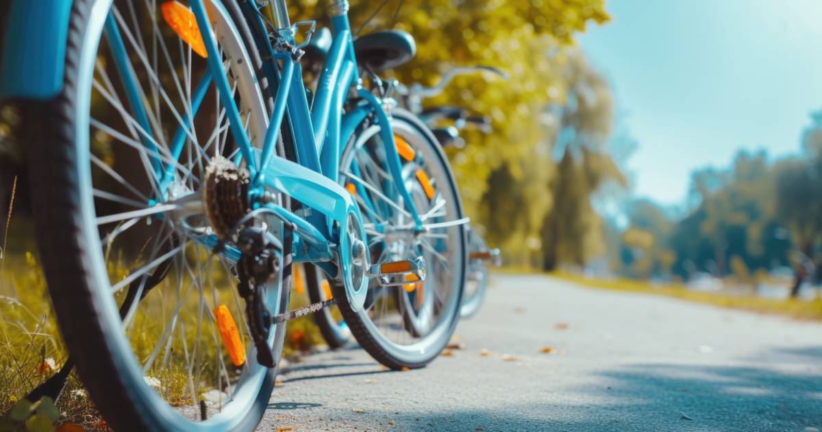 Geparkeerde blauwe fiets op een pad met bomen