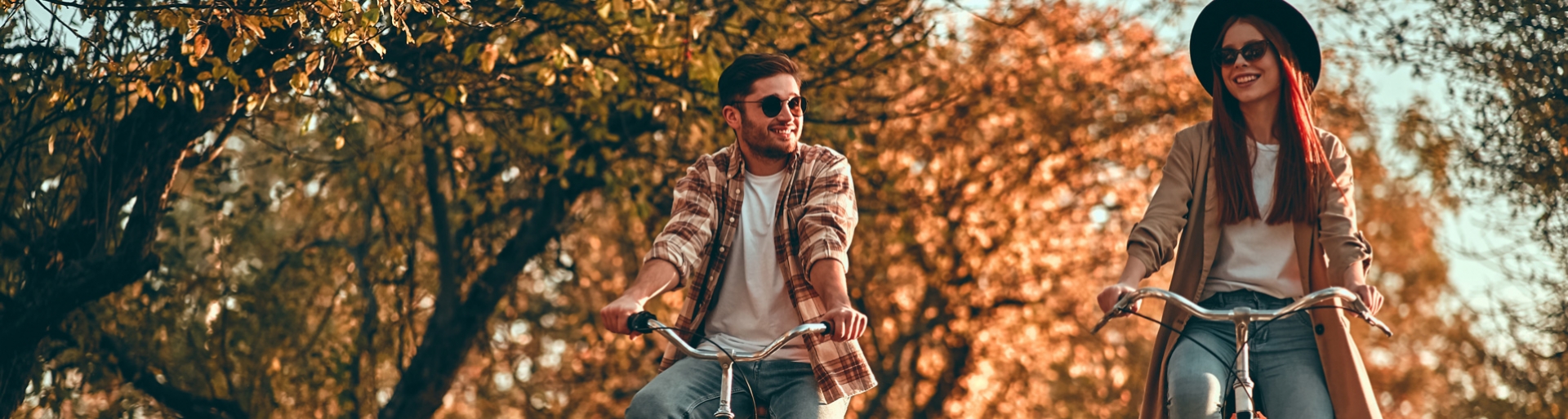 Een jongen en meisje fietsen in het park in de herfst